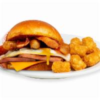 BBB Breakfast Sandwich · 2 fried Eggs, Ham, Bacon, Sausage, and American Cheese on a toasted Brioche Bun.  Served wit...