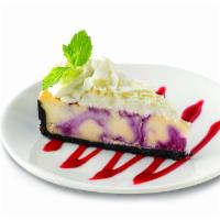 White Chocolate Raspberry Cheesecake · Creamy cheesecakes swirled with imported seedless raspberry and pieces of white chocolate ba...