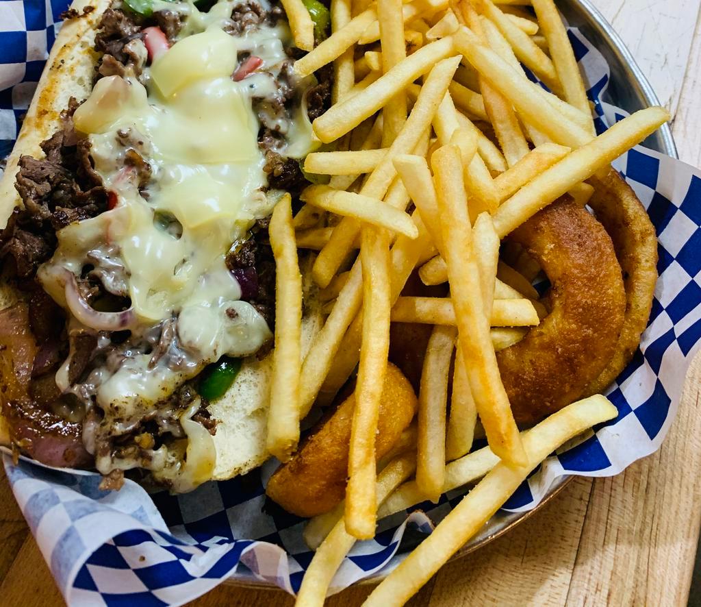 Philadelphia Cheese Steak Sandwich · Thin sliced ribeye, onions, American cheese and sauteed mushroom. Served with fries and onion rings.