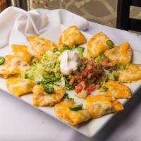 Nachos · Choice of 1 meat: beef, chicken or marinated pork. Served with beans, cheese, jalapenos, let...