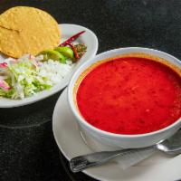 Pozole Soup · Traditional Mexican soup made with hominy. Pork garnished with shredded cabbage, chili peppe...