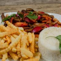 Lomo Salteado · Sauteed beef with onions and tomatoes, served over fries and rice.