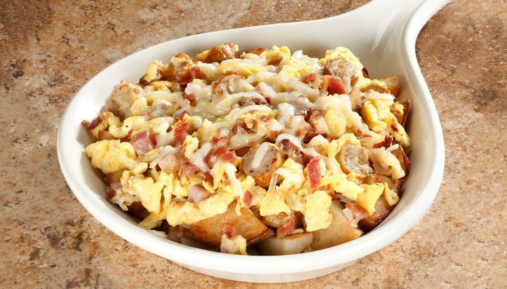 Meat Lover's Skillet · Two scrambled eggs, ham, crumbled sausage, bacon on a bed of seasoned home fries topped with cheddar cheese.			