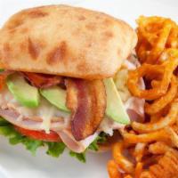 California Club Sandwich · Smoked turkey, jack cheese, bacon, sliced avocado on a toasted ciabatta bun, lettuce and tom...