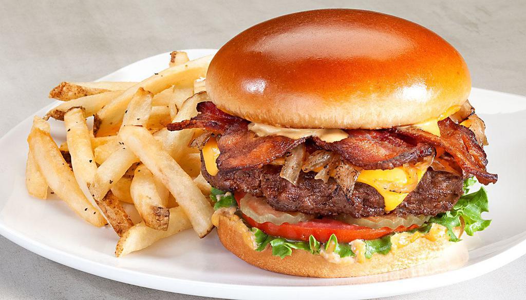 Smoky Chipotle Burger · Bacon, caramelized onions, American Cheese, spicy chipotle mayo, lettuce, tomato, pickles.