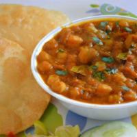 Choley Bhature · Puffed fried bread served with garbanzo beans.