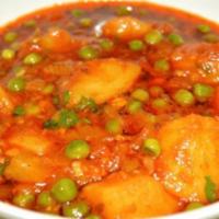 Aloo Mattar · Green peas and potatoes cooked in onions tomato gravy.