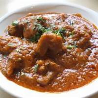 Karahi Goat  · Goat cooked in butter gravy with bell peppers, onions, tomatoes and spices.