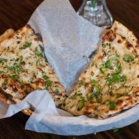 Garlic Naan · Leavened bread cooked with fresh garlic and cilantro.