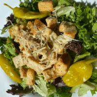 Chicken Caesar Salad · Chicken breast, Parmesan cheese and herbed croutons on a bed of mixed greens with creamy Cae...