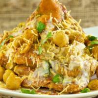 Chole Samosa Chaat · Samosa crushed and blended with garbanzo curry garnished with sweet and spicy sauce to the p...