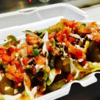 Nachos · Special nacho cheese, choice of meat, guac, red salsa, pico, sour cream and jalapenos.