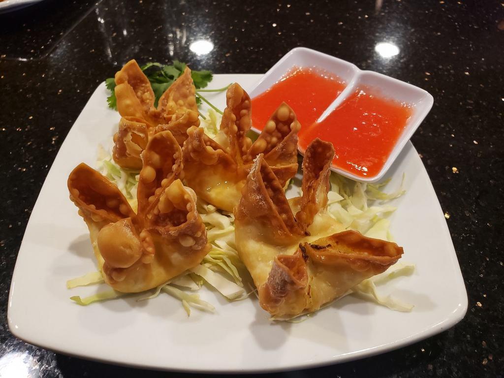 Crab Rangoon · 4 piece. Fried wonton skin stuffed with crab and cream cheese.
