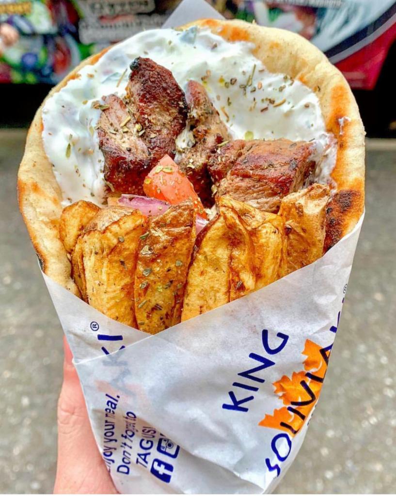 Pork Souvlaki Pita Sandwich · Perfectly grilled pork souvlaki wrapped inside of a warm and toasty pita with delicious fillings of your choosing. 