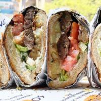 Loukaniko Hero Sandwich · Two pieces of our Handmade Greek Pork Sausage on a lightly grilled Hero sandwich with fillin...