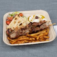 Pork Souvlaki Platter · 2 sticks of our hand skewered pork souvlaki over our handcut fries or yellow rice. Comes wit...