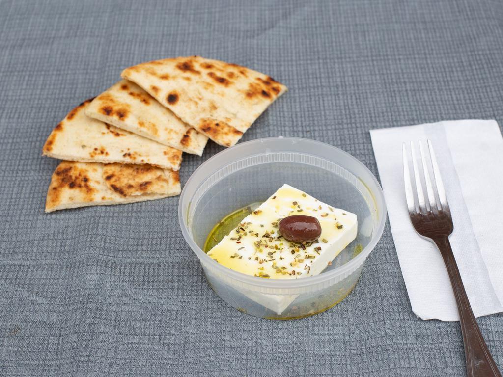 Feta Cheese · Greek Imported Feta Cheese made from Sheep and Goat Milk. Served with bread.