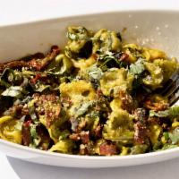 Pesto Tortellini · Cheese Filled Tortellini Served with Homemade Creamy Pesto, ＆ Sun-Dried Tomatoes. Topped wit...