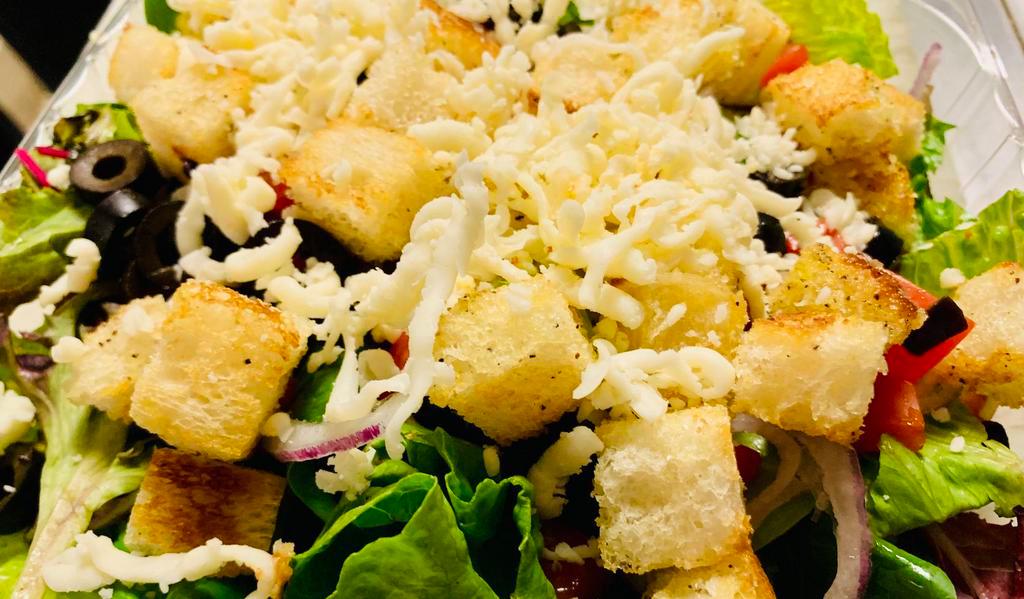House Salad - Side Size · Spring Mix & Hand Chopped Romaine, Sliced Black Olives, Diced Tomatoes, Sliced Red Onions a little Mozzarella Cheese & Croutons. 
Served with one 2oz side of dressing.