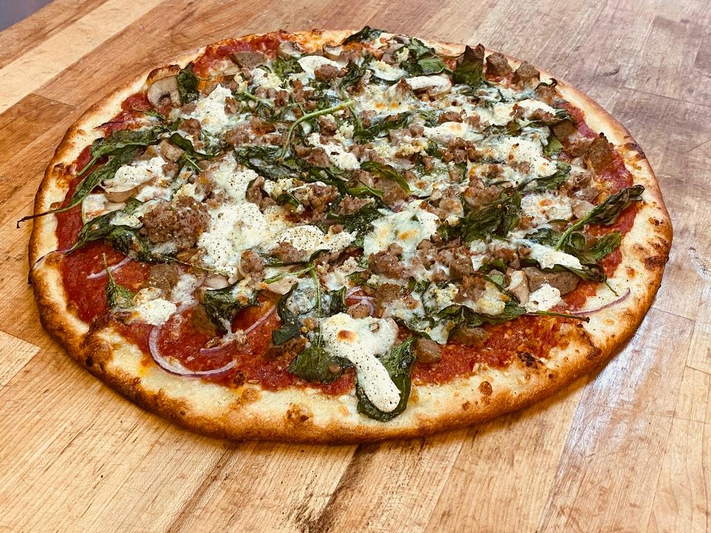*NEW* The Switzer Pizza · Extra Thin Pink Sauce Pizza, Sliced Red Onions, Meatball Pieces, Fresh Mushrooms, Fresh Spinach, Seasoned Ricotta, Italian Sausage Crumbles, Topped with Fresh Garlic and a light amount of Freshly Shredded Mozzarella Cheese & Spices to finish it off!