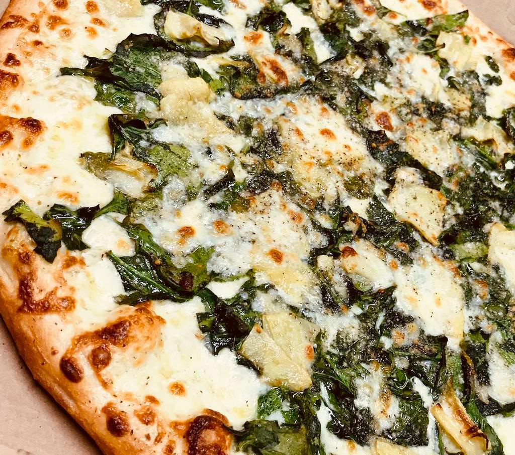 Spinach N' Artichoke White Pizza · Our Thin Crust White Pizza made with Fresh Garlic, Corto® Olive Oil & Spices, Freshly Shredded Mozzarella, Fresh Baby Spinach, Marinated Artichokes and a little extra cheese then seasoned with spices and Romano Cheese over the top.