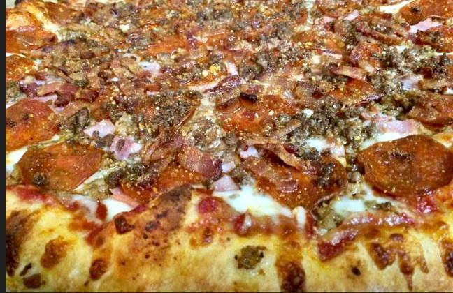 Meat Lovers Pizza · Our Homemade Red Pizza Sauce, Freshly Shredded Mozzarella, Chopped Virginia Ham, Italian Sausage Crumbles, Traditional Pepperoni, Thick-Cut Bacon Pieces and Seasoned Beef Crumbles, topped with Romano cheese.