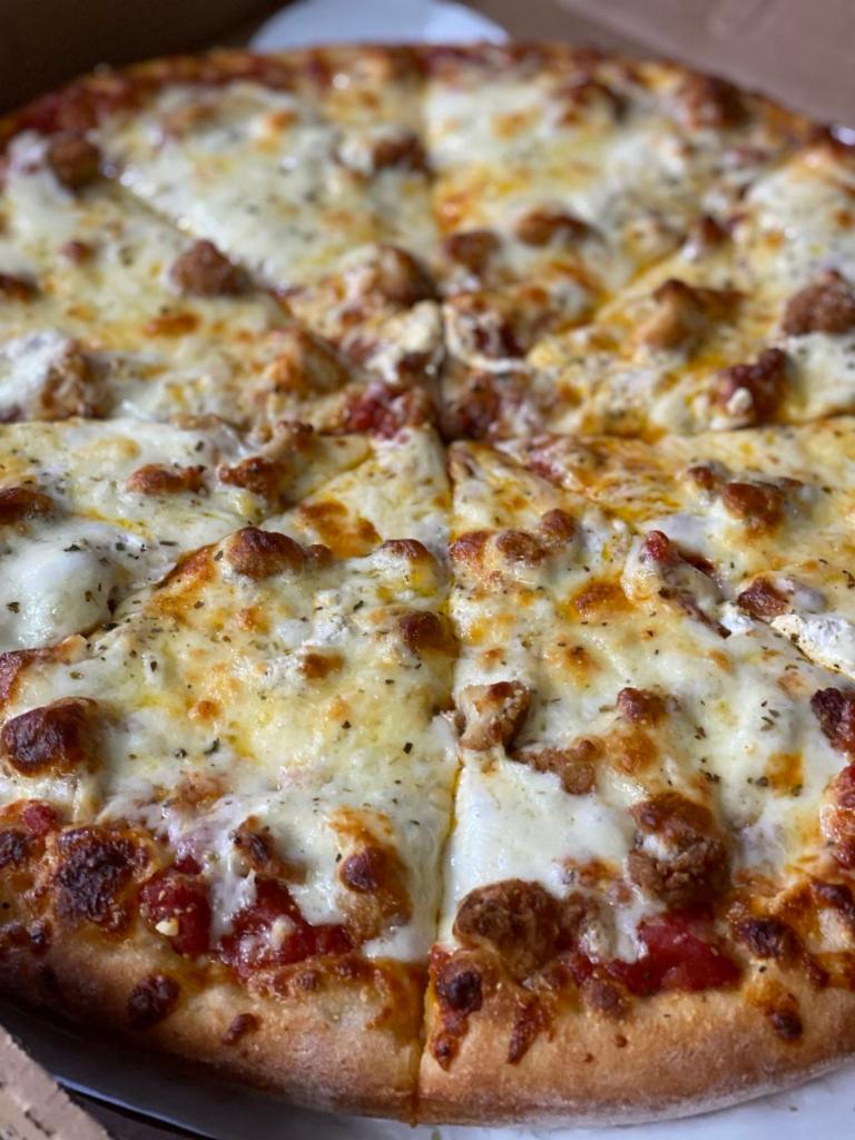The Chicken Taz Pizza · Our Marinara Sauce, Crispy Boneless Chicken Pieces, Seasoned Ricotta Cheese, Freshly Shredded Mozzarella, Provolone Cheese and topped with Romano Cheese & Spices.