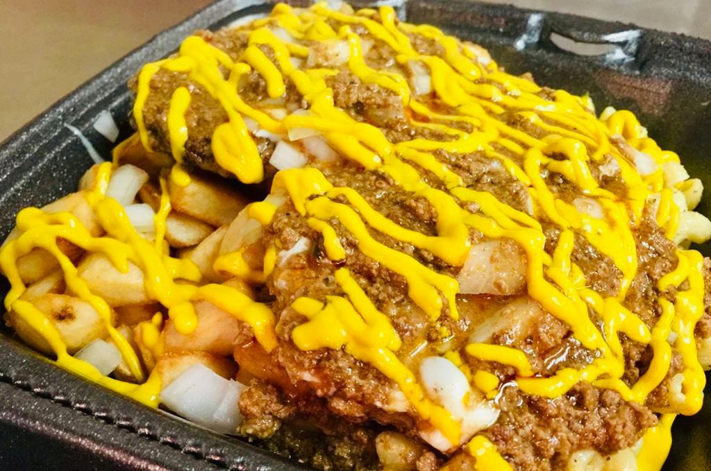 Cheeseburger Corner Plate · This Rochester favorite has all you're looking for!  Two 1/4 lb. cheeseburger's served on top of your choice of two sides. Then hooked up with toppings of your choice. 
(Our everything includes French's© Yellow Mustard, diced yellow onions and our homemade meat hot sauce)