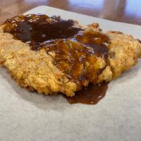 Chicken Fried Steak · A hand-breaded, seasoned & hand hammered breaded tender Angus beef steak. Served with two si...