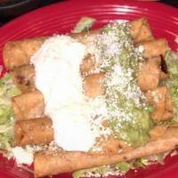 Fried Taquitos · 5 deep-fried chicken or shredded beef taquitos. Served on a bed of lettuce. Topped with sour...