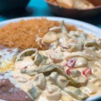 Pollo en Crema · Chunks of chicken breast sauteed with onions, bell peppers and spices with our secret sour c...