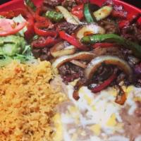 Carnitas de Res · Flank steak sliced then fried with bell peppers and onions served with rice, beans, lettuce,...