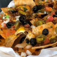 Chipotle Nachos · Chipotle nachos crispy corn tortilla chips topped with jalapeños, black olives, tomatoes and...