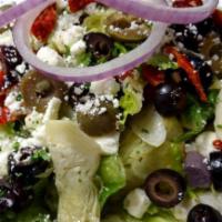 GF Zesty Greek Salad · Crisp garden greens with sun-dried tomatoes, artichoke hearts, cucumber and a blend of seaso...