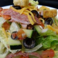 Italian Chopped Salad · Crisp romaine lettuce tossed with Italian herb dressing, ham, salami, pepperoni, bacon, seas...