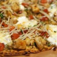 Bruschetta Flatbread  · Basil pesto, chicken, seasoned tomatoes, garlic, fresh mozzarella and parmesan on a crisp mu...