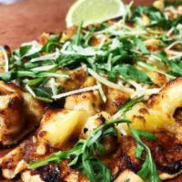 Jamaican Jerk Flatbread  · Tender chunks of white meat chicken breast drizzled with Jamaican jerk sauce, topped with pi...