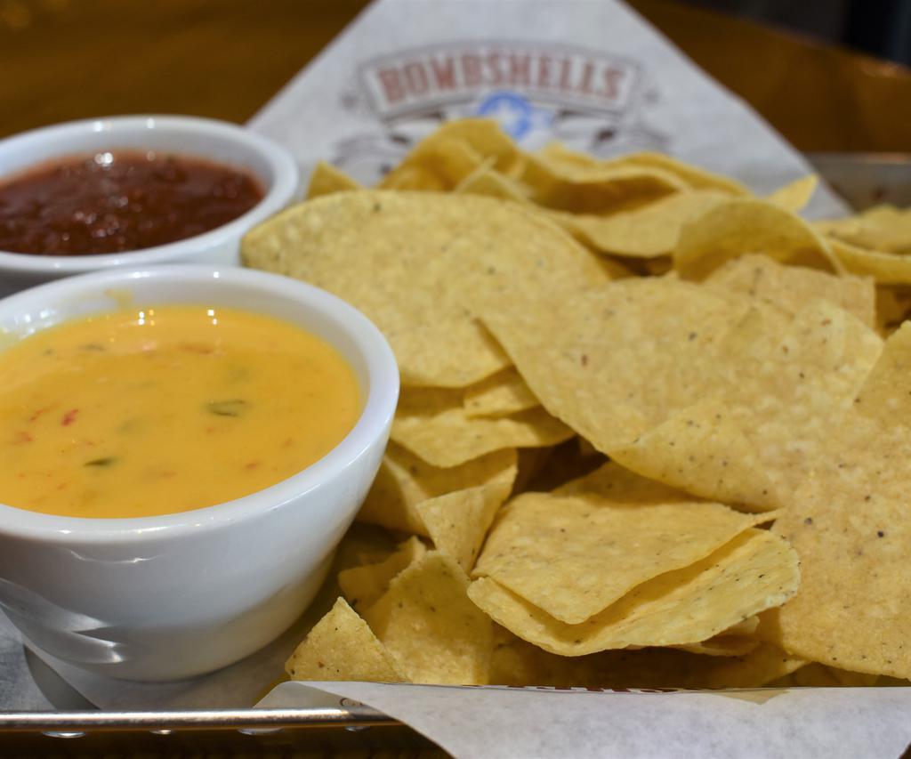 Chips & Queso · Creamy golden queso cheese blended with tomatoes, onion, peppers and cilantro. Served with tortilla chips. Add chili for an additional charge.