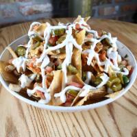 Macarthur's Supreme Commander Nachos · A heaping helping of tortilla chips piled high with chicken or steak, spicy queso, jalapeno,...