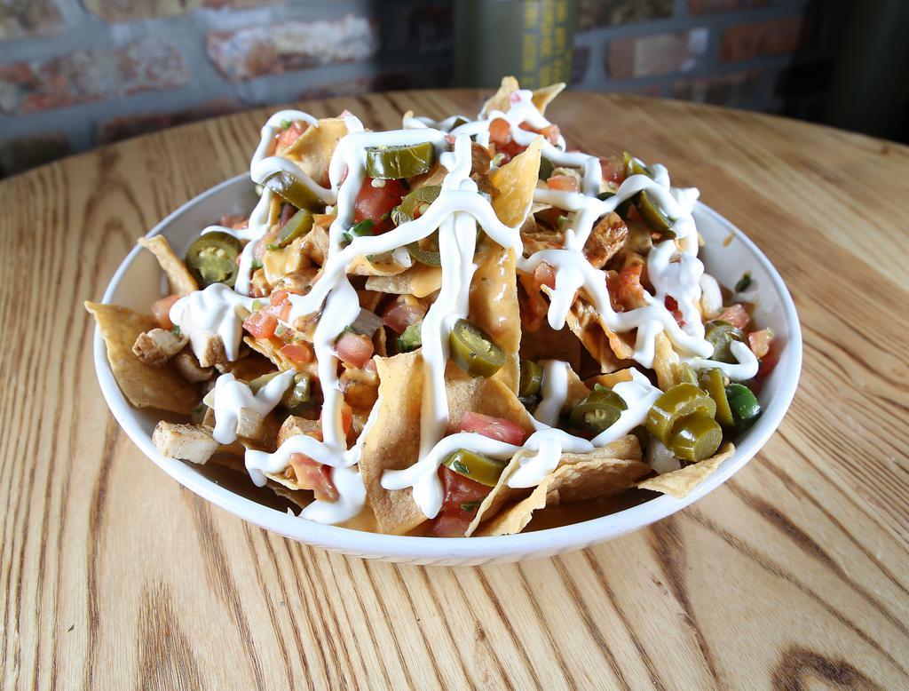 Macarthur's Supreme Commander Nachos · A heaping helping of tortilla chips piled high with chicken or steak, spicy queso, jalapeno,sour cream and pico.
