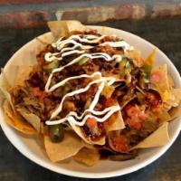 MP PULLED PORK NACHOS  · Tortilla chips filled high and topped with tender shredder pork, spicy queso and cheddar che...