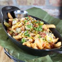 Locked & Loaded Cheese Fries · Crispy fries fried high, smothered with jack, cheddar and spicy queso cheese then topped off...