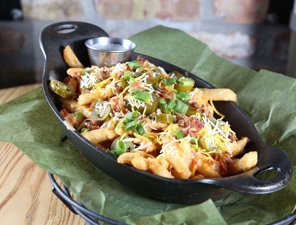 Locked & Loaded Cheese Fries · Crispy fries fried high, smothered with jack, cheddar and spicy queso cheese then topped off with bacon, chives and jalapenos. Served with ranch.