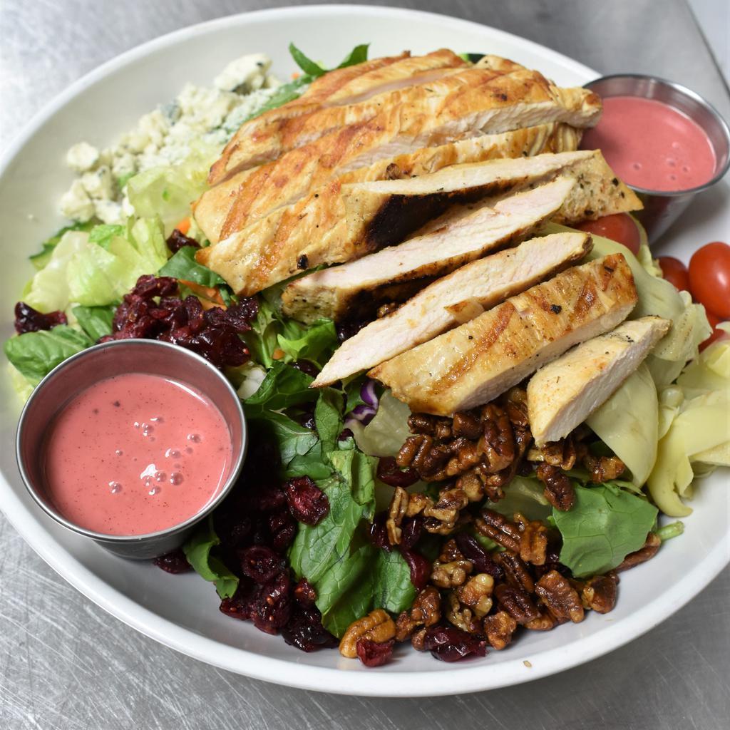 The Pin Up Girl Salad · Fresh greens topped with cheesy tomatoes, artichoke hearts, sweet pecans, dried cranberries, blue cheese crumbles and fresh cucumbers. Served with balsamic raspebery vinaigrette, finished off with grilled chicken.