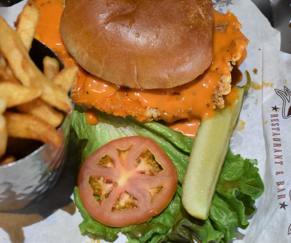 Carmen Miranda · A plump chicken breast grilled to perfection, tossed in a spicy Buffalo sauce and topped with peppers jack cheese. Served on a toasted bun with lettuce and tomatoes.
