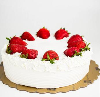 Strawberry Cake · Vanilla sponge cake layered with fresh strawberries and whipping cream. Decorated with fresh strawberries as well.