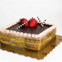 Hazelnut Truffle · Chocolate cake layered with hazelnut flavored truffles. Decorated with chocolate tags and fr...