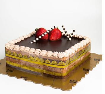 Hazelnut Truffle · Chocolate cake layered with hazelnut flavored truffles. Decorated with chocolate tags and fresh strawberries.