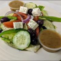 Greek Salad · On a bed of lettuce, with fresh tomatoes, cucumbers, red onion, Greek pepperoncini peppers, ...