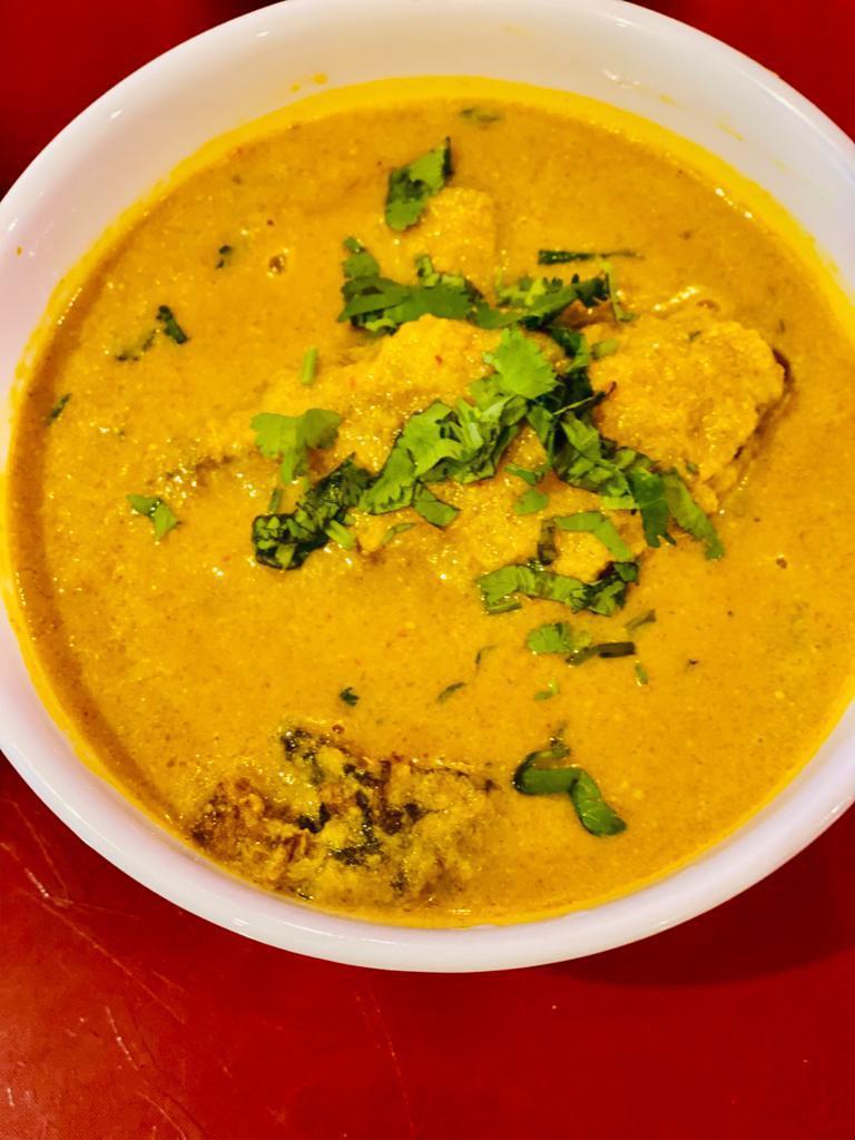 Fish Curry · Fish cooked in authentic Indian curry.